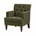 Fauteuil en velours vert avec accoudoirs cloutés